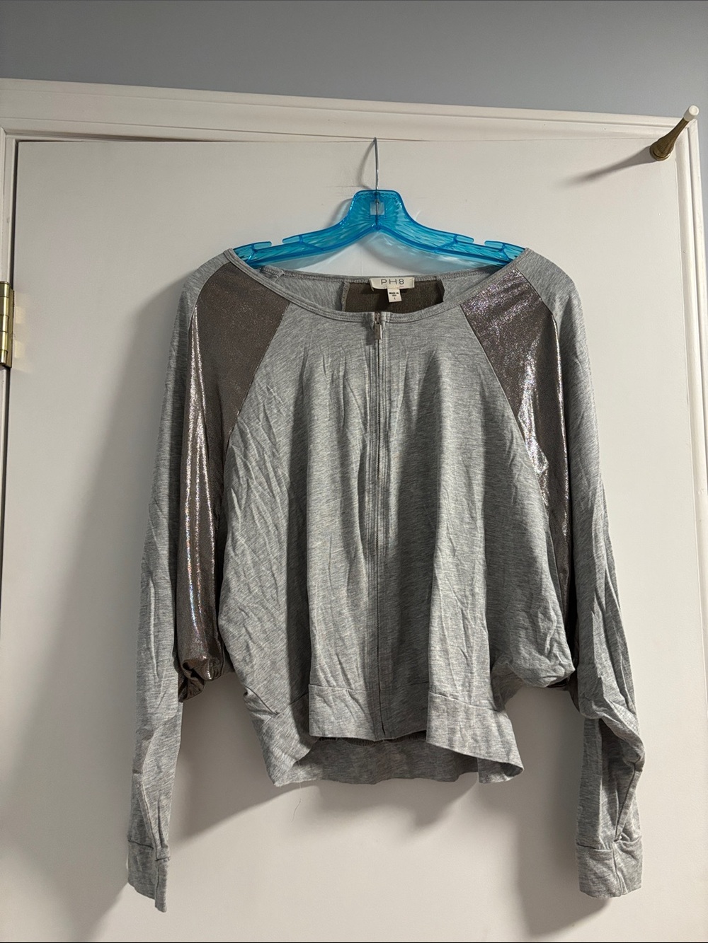 Gray zip-up top by PH8 featuring distinctive metallic shoulder panels/back